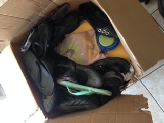 sample box packed w/ shoes,drinking jug and books all in the same