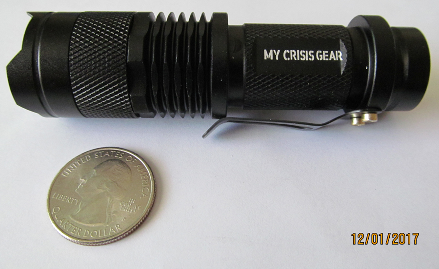 The quarter in this photo shows the miniscule size of this "tactical flashlight."
