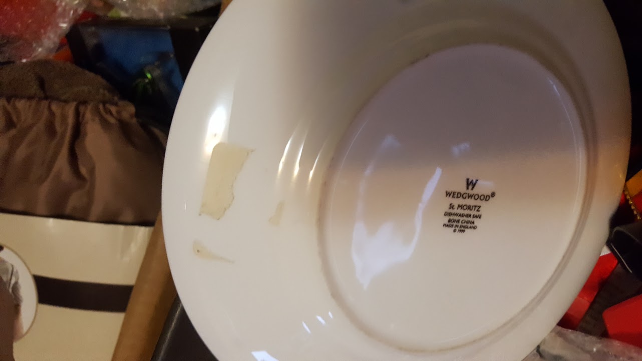 Random plates with masking tape on them, used, fork and knife marks on them