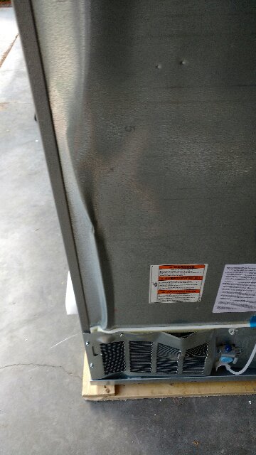 Another photo of the damaged refrigerator.