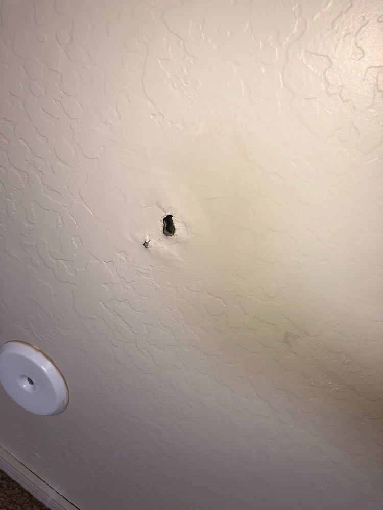 Hole in wall of room with sewage leak