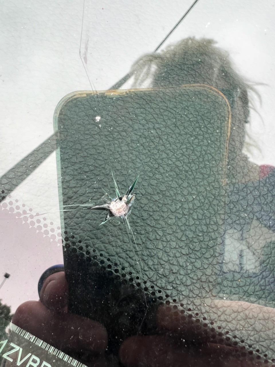 Bullet hole in the windshield, possibly mother