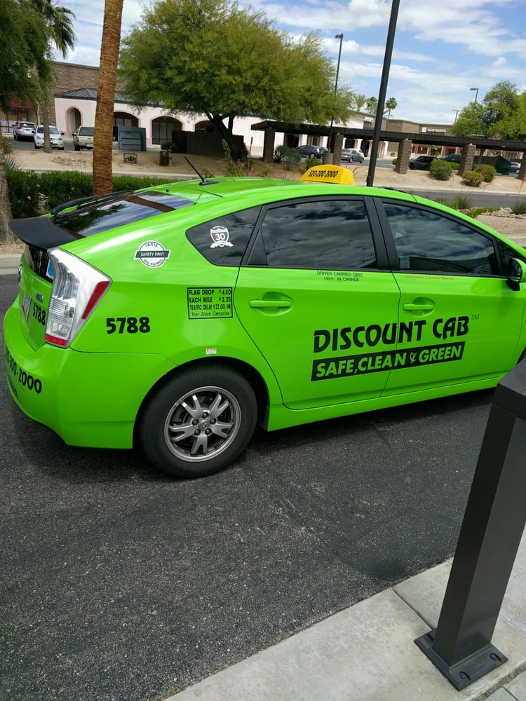 A typical Discount Cab - A Green Toyota Prius.