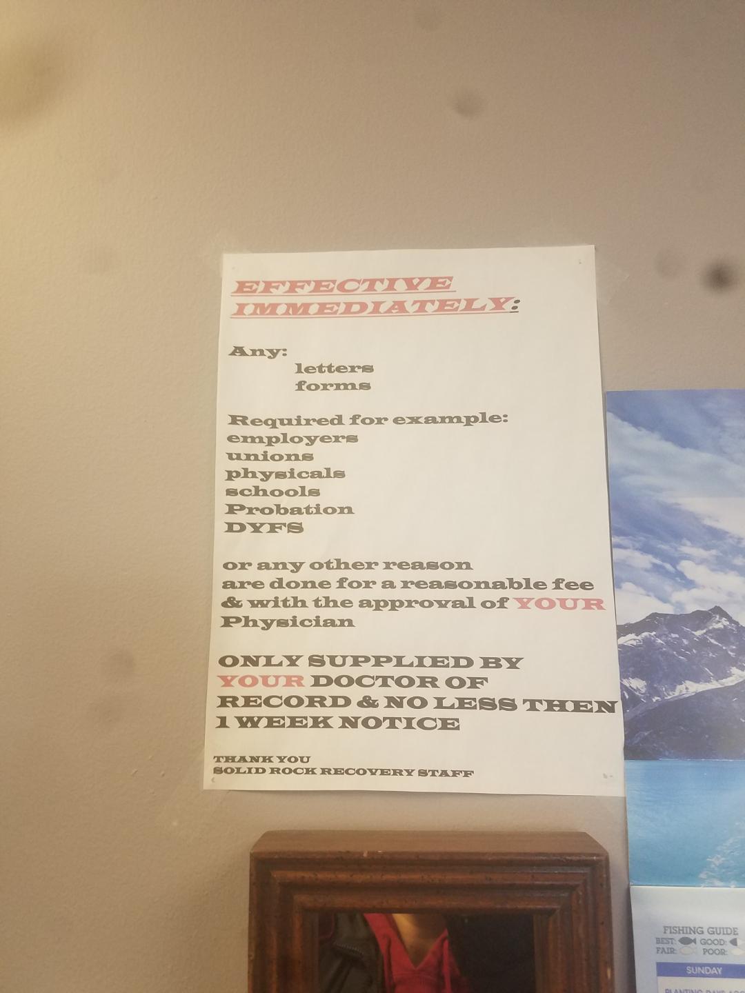 Letter hanging on wall next to check in desk