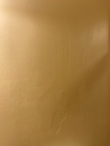 damaged wall by worker painted over