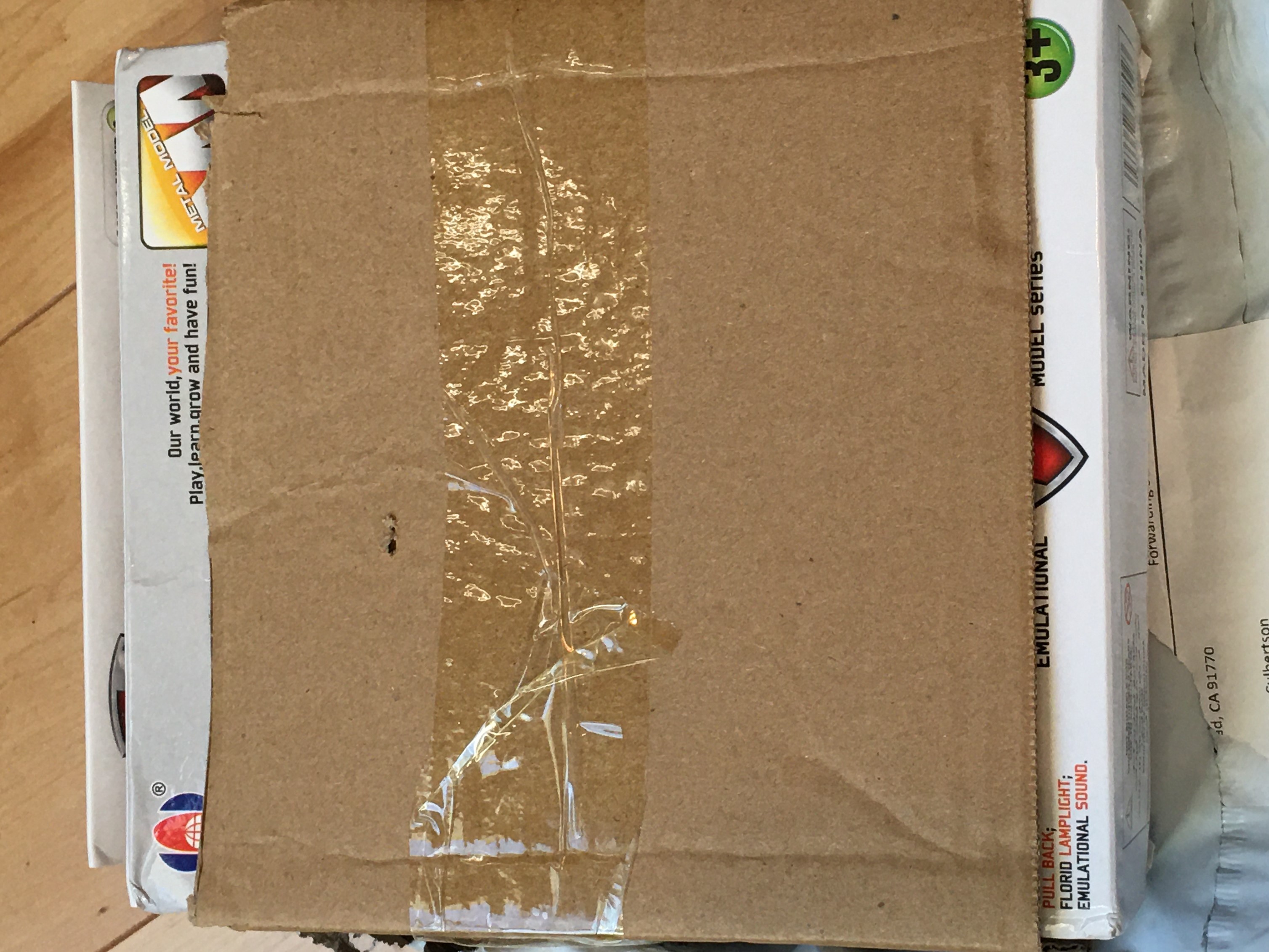 cardboard covering the front of toy airplane