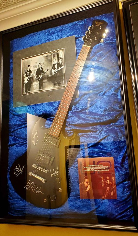 Fake U2 autographs on a guitar