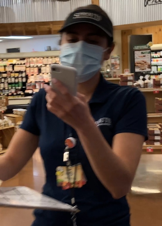 Michelle using her personal phone at grocery store