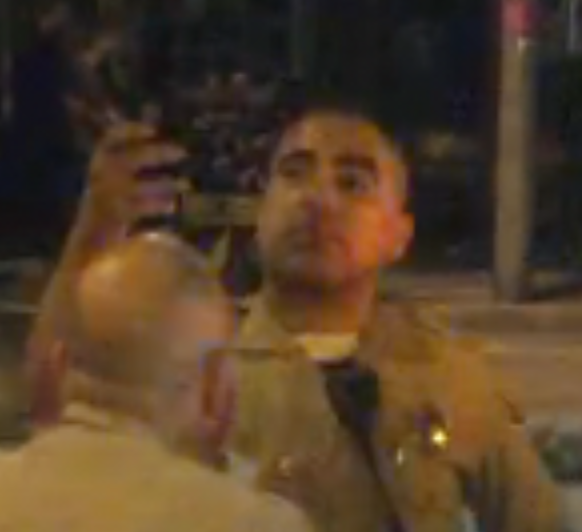 Deputy mocking us as we took video and photos of him after illegally arresting our friend.