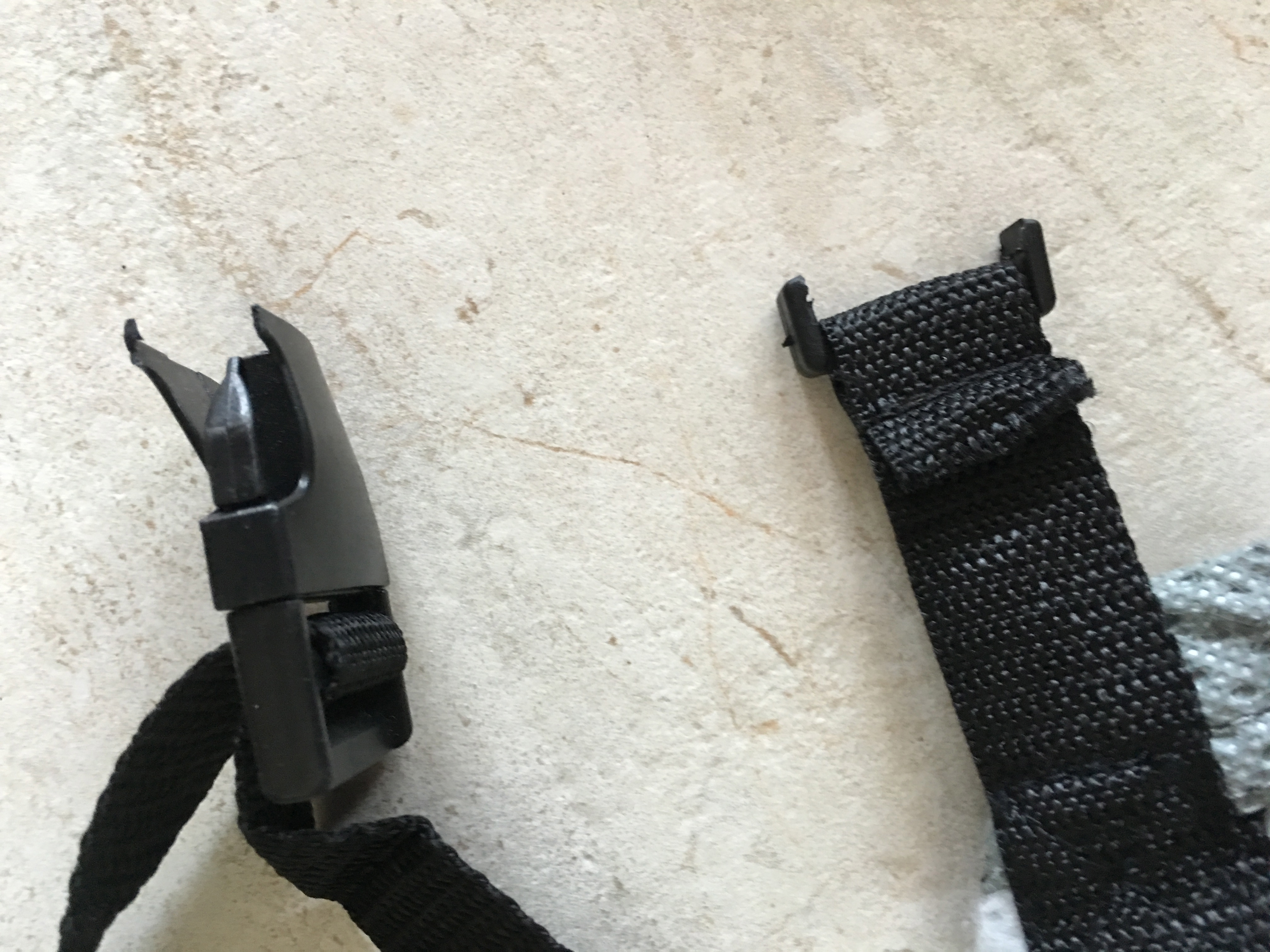 the two cheap broken buckles which need to be intact to snap or buckle together to hold the cover down from side to side under the vehicle.