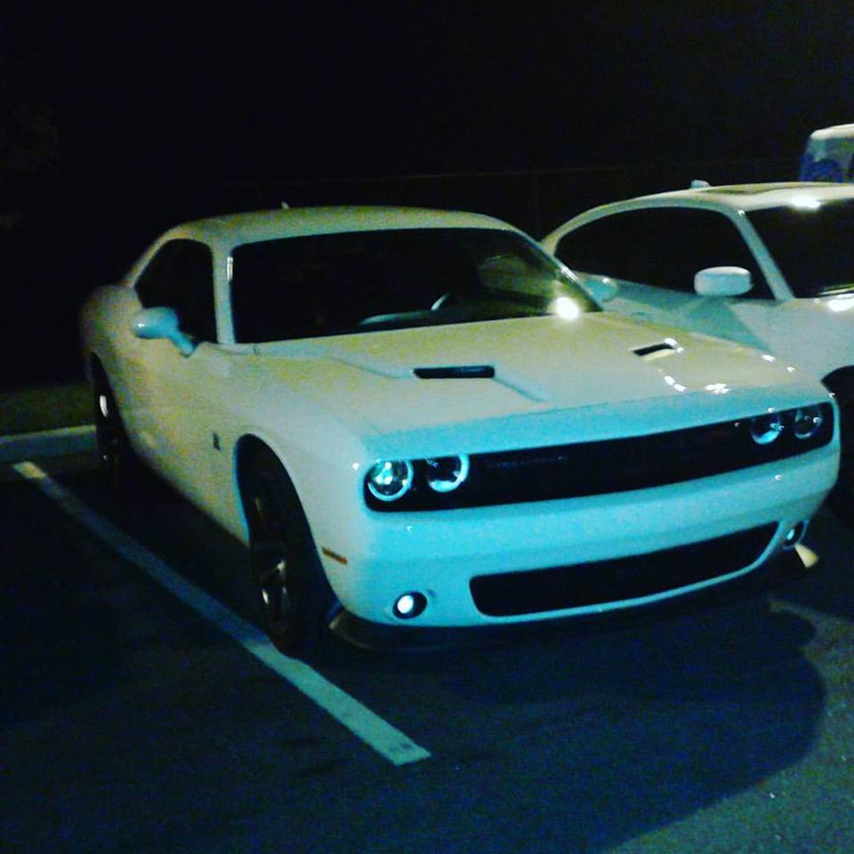 in the parking lot of his house charger challenger and a little bit of his detailing van