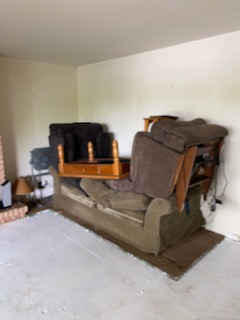 2 recliners, coffee table piled on sofa