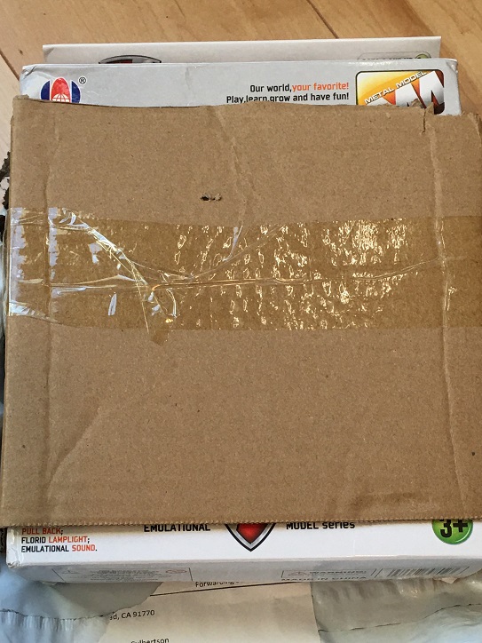 cardboard covering the front of toy airplane