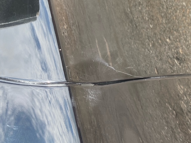 Dent on the driver side of vehicle in the hinge of