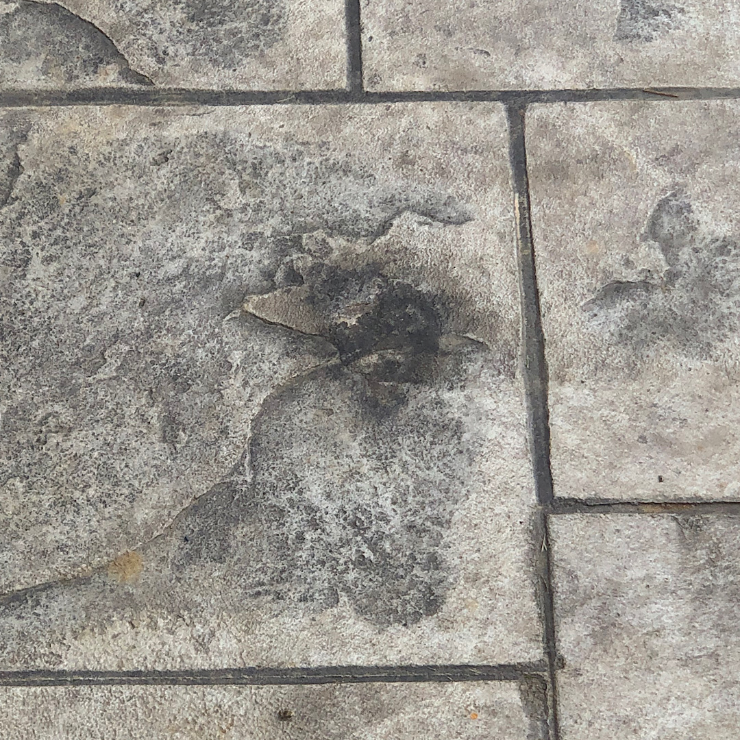 Poor repair of hole made in stamped concrete 
