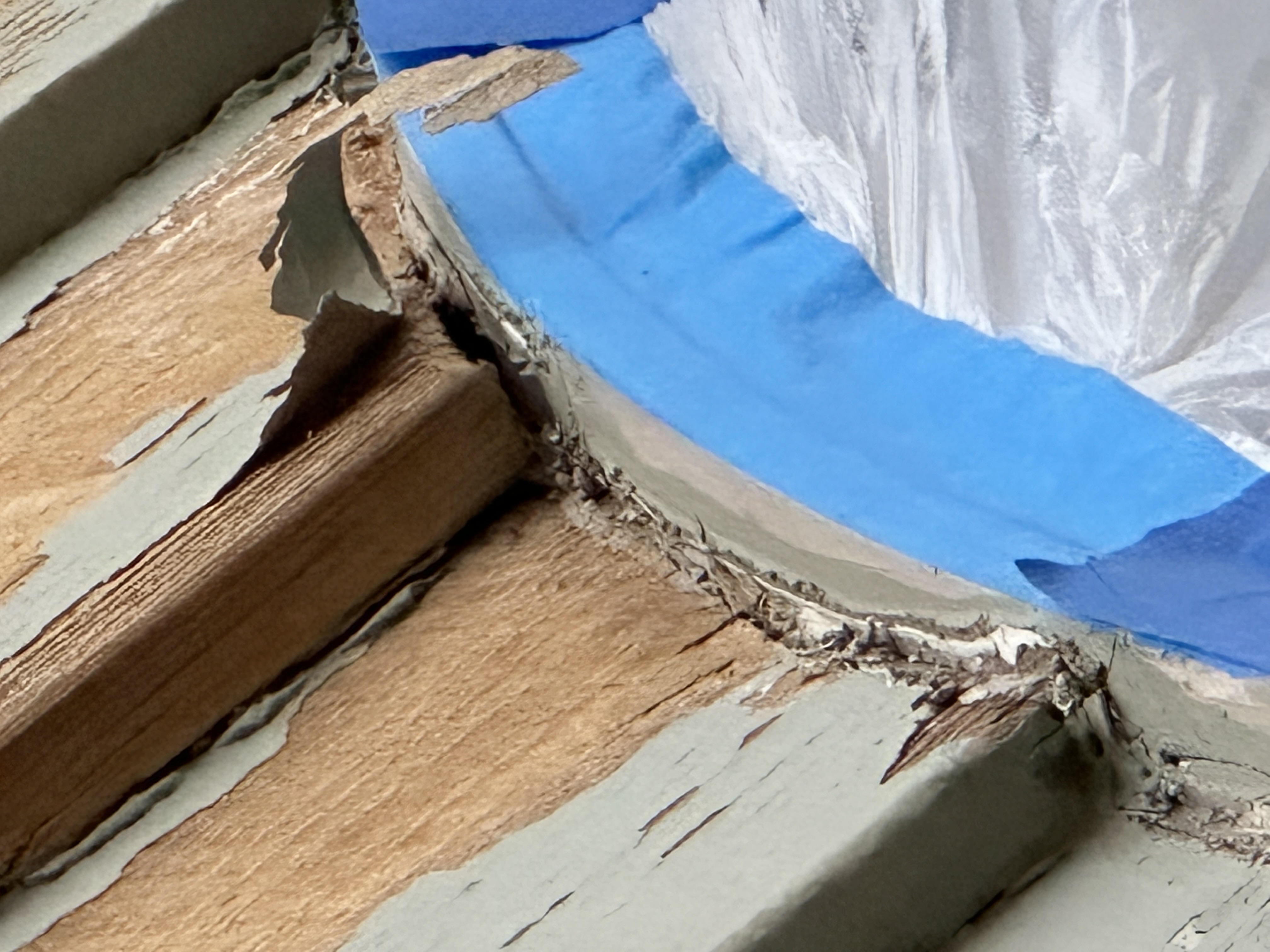 Loose paint not scraped off wood prior to painting