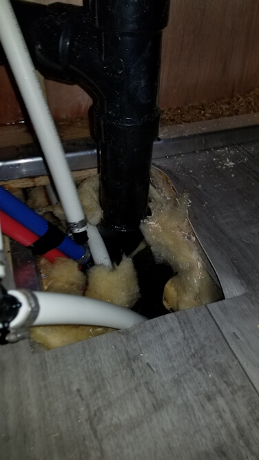 Wet and damaged floor from leaking PEX pipe